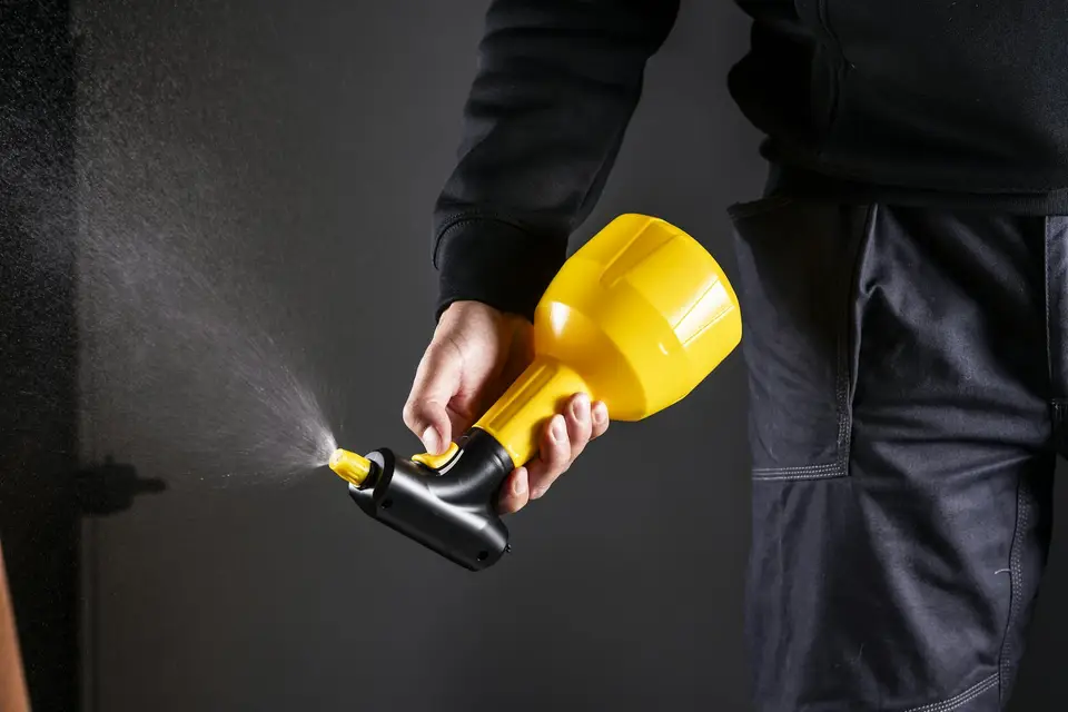 A hand-held sprayer in use
